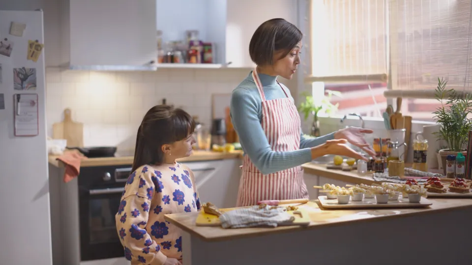 Fotograma: madre e hija cocinan juntas.